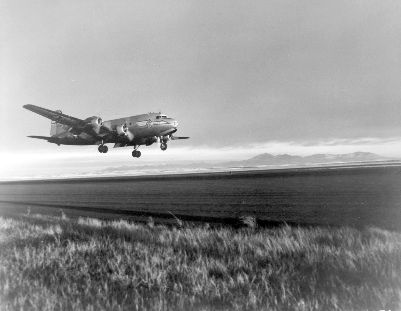 A Douglas C-54 Skymaster practices a "Tempelhof Landing" at Great Falls Air Force Base, Mont. Student pilots were taught this special type of landing to simulate flight conditions at Tempelhof airport, Berlin. The approach glide angle is very steep and the airplanes touch down with a high-nose altitude and are held nose-high until engines slow down. This causes the wing to act as an airbrake and use of the wheel brakes is cut to a minimum. (U.S. Air Force photo)